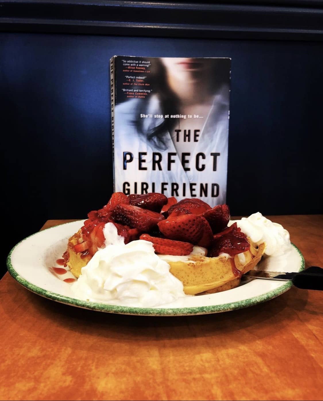the perfect girlfriend by karen hamilton book with a plate full of food set on a table